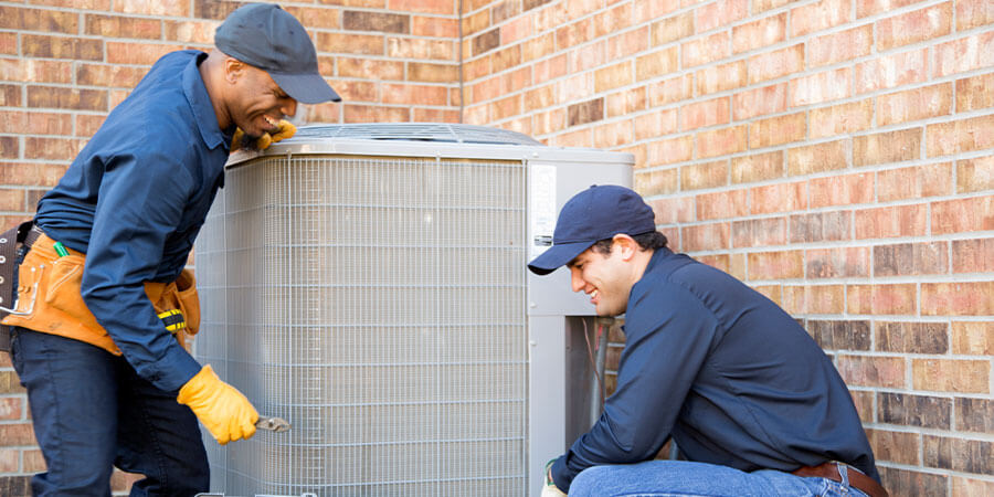 service technicians working on air conditioner